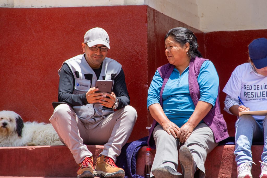 Practical Action staff interviewing community member as part of FRMC data collection. Photo by Practical Action Peru