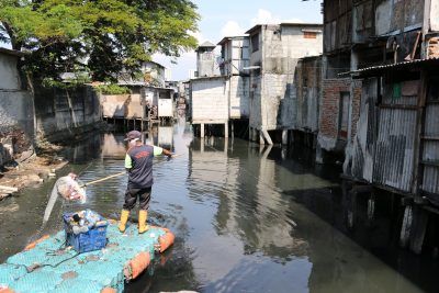 Cleaning waste from river in Penjaringan Urban Village, Jakarta, Indonesia