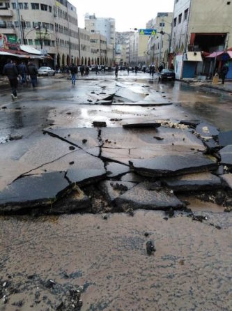 A main street in Amman downtown is damaged due after a flood event