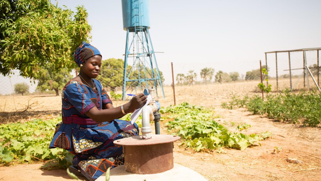 Fatimata Coulibaly and Awa Dembélé, members of the Benkadi women's group, using an electric probe to measure the water level inside a well inside the market garden, Kakounouso, Samabogo, Mali. WaterAid/ Basile Ouedraogo