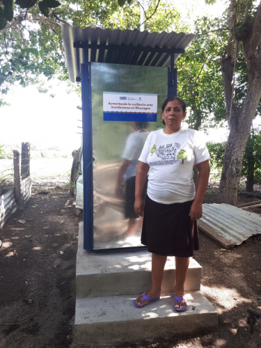 Doña Brenda in front of her new flood-proof latrine. Community of Paniquines, Chinandega, Nicaragua. April, 2021